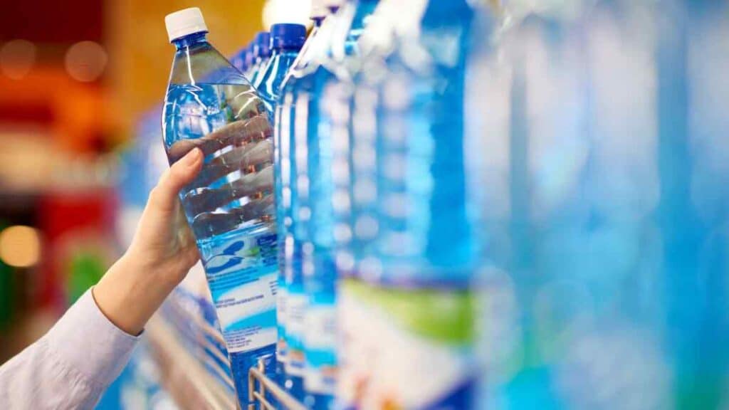 Buying a bottle pf water in the grocery.