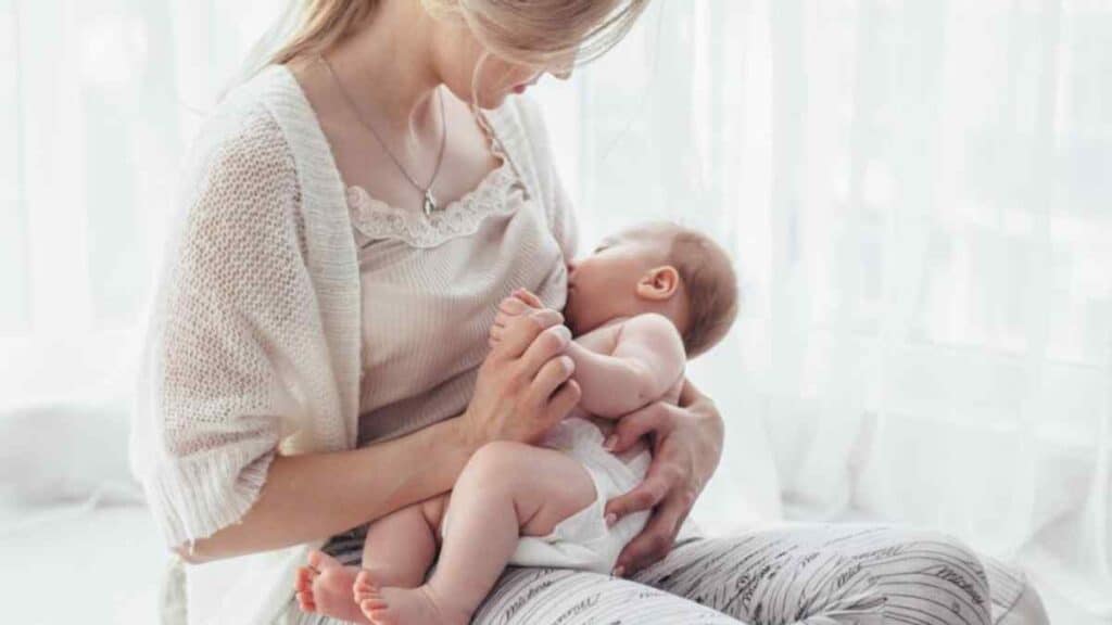 A baby drinking milk on her mother.