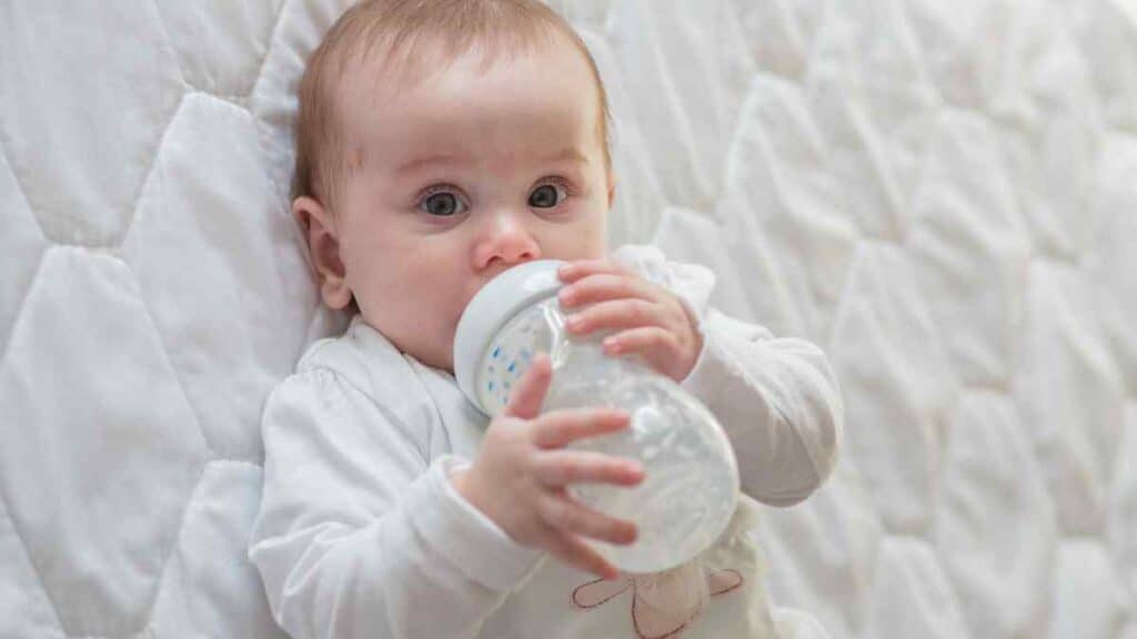 baby drinking in white background.