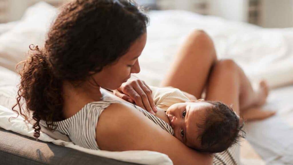 Black woman breastfeed her baby.