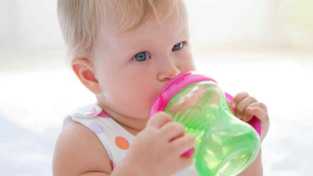Baby Drinking on her Green Water Bottle
