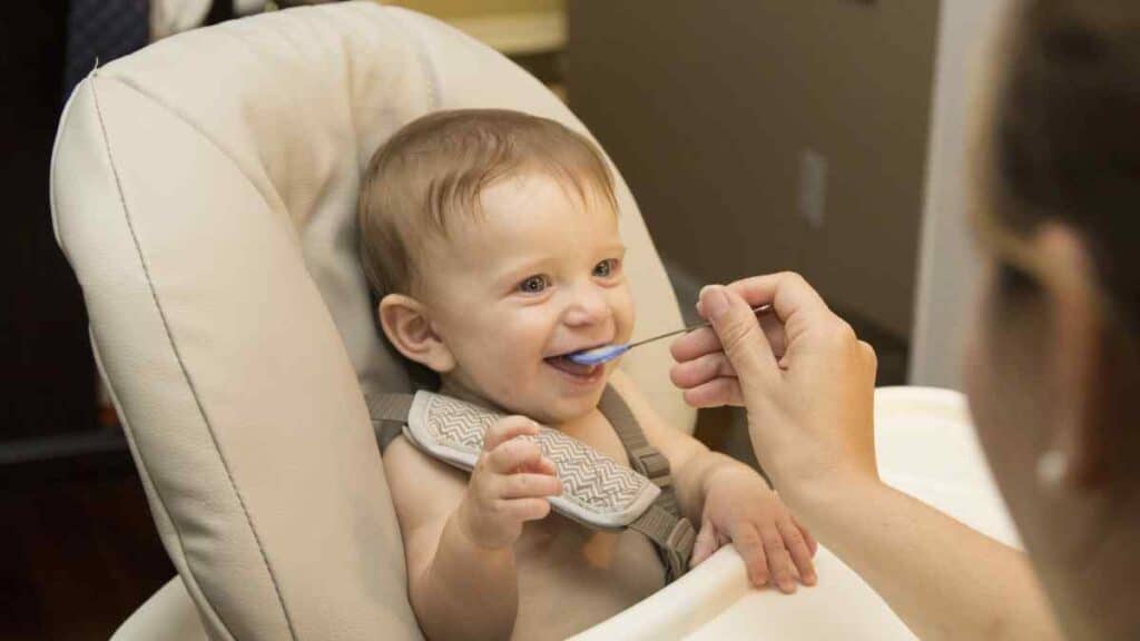 Smiling infant while eating.