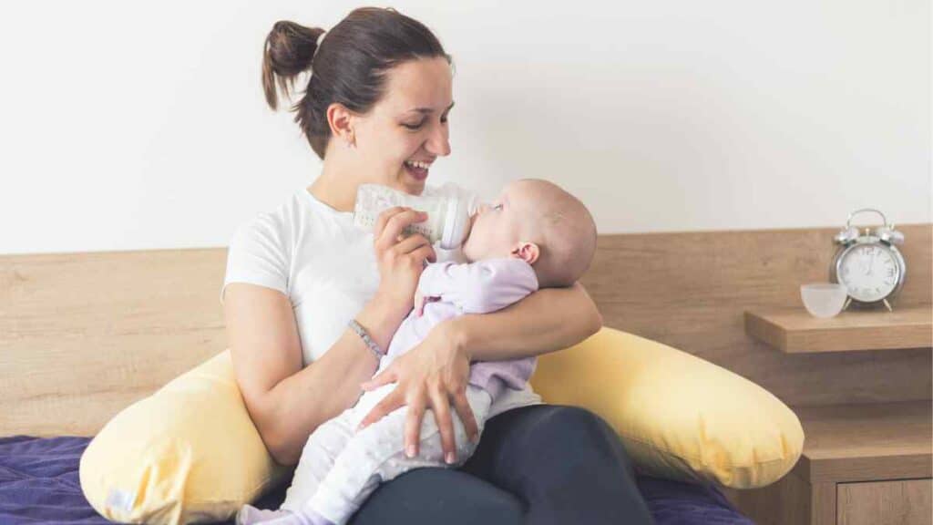 A mother feeding Breast Milk and Formula.