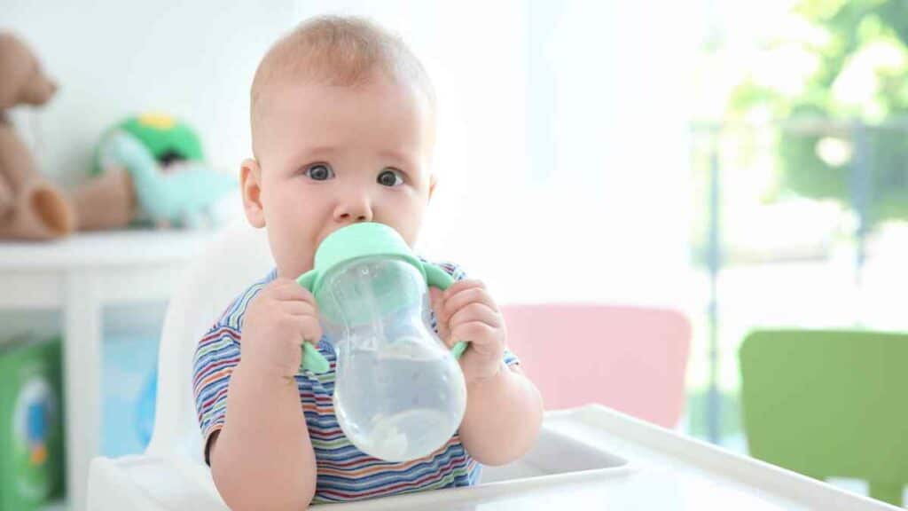 Baby drinks water. 