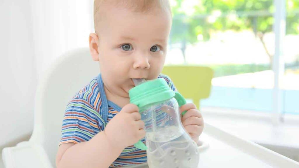 Baby drinks in bottled water. 