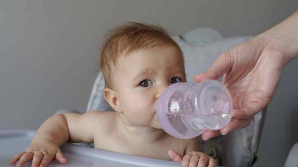 Helping an infant to drink.