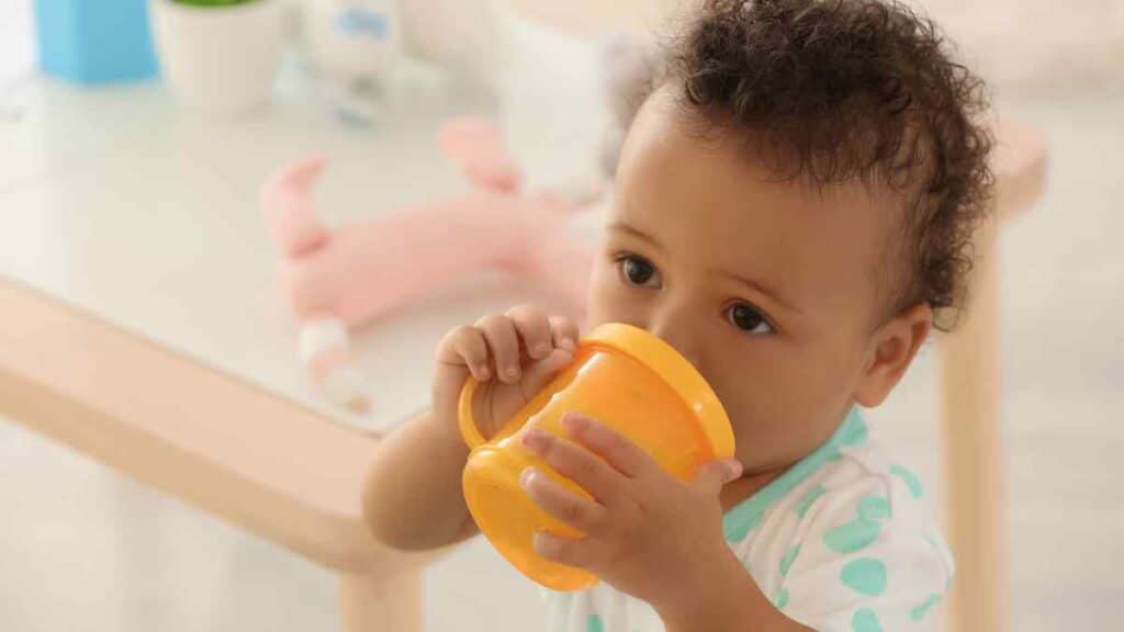 baby drinks in yellow bottle