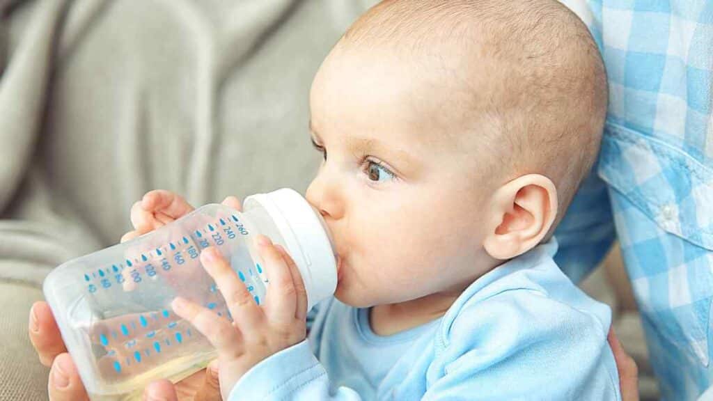 The baby with clean bottled water.