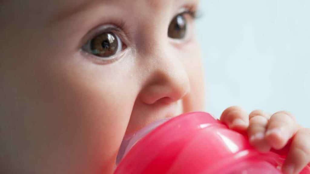 Baby and red sippy cup.